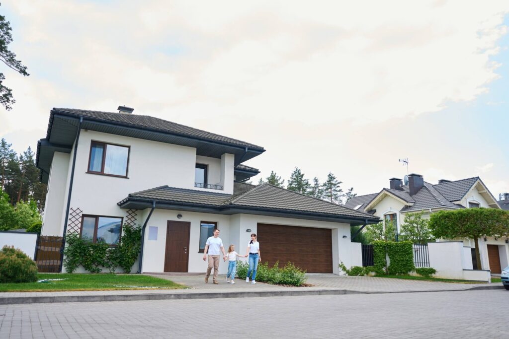 family standing next to their home