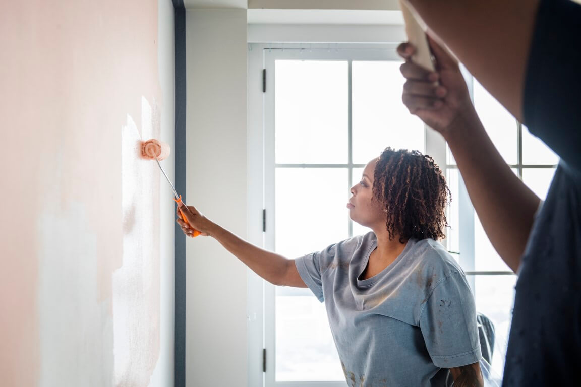 people painting a wall
